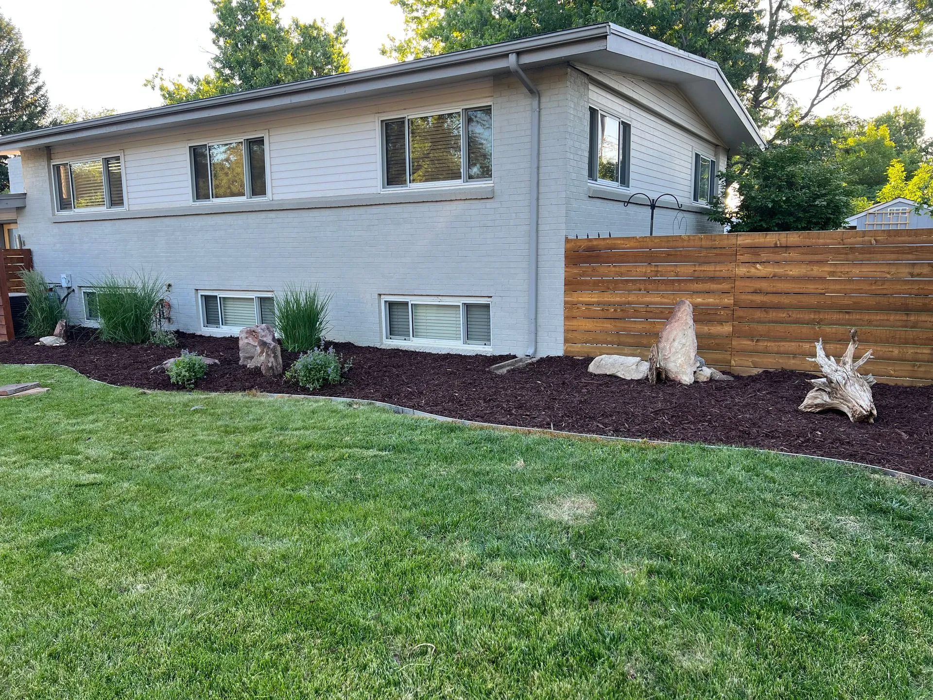 Outdoor landscaping Denver with decorative rocks, plants, and sustainable garden design